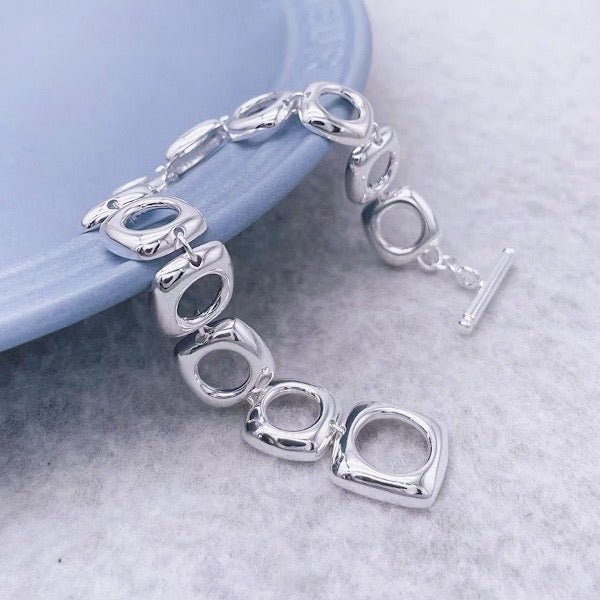 Bold look, sturdy sterling silver bracelet with square frame links and OT clasp