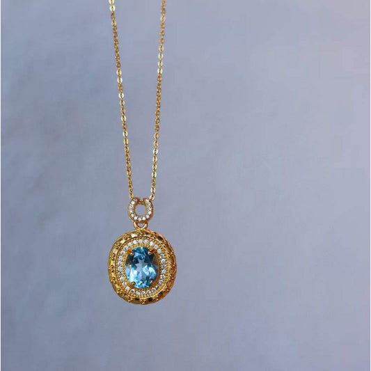 Blue Topaz Gold Framed Oval Pendant Necklace