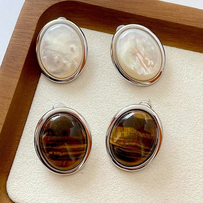 Oval stud earrings with tiger eye stone and MOP in a striking look